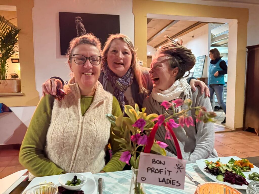 Drei Frauen beim Essen und Lachen.
